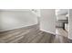 Spacious living room with laminate flooring leading into kitchen with white cabinetry at 5529 Wood Pond Ct, Raleigh, NC 27610