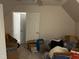 Attic with open white door cluttered with belongings at 5816 Henner Pl, Durham, NC 27713
