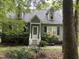 Charming two-story home features a welcoming front porch, complemented by mature landscaping and lovely curb appeal at 5816 Henner Pl, Durham, NC 27713