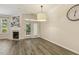 Light-filled dining room featuring a fireplace and french doors to the exterior at 5936 Hourglass Ct, Raleigh, NC 27612