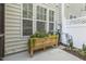 Exterior view with a charming planter box under the windows, adding a touch of nature at 5936 Hourglass Ct, Raleigh, NC 27612