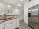 Well lit kitchen offering granite counters, stainless steel appliances, and stairs in the background at 5936 Hourglass Ct, Raleigh, NC 27612