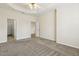 Spacious main bedroom featuring plush carpet and tray ceiling at 5936 Hourglass Ct, Raleigh, NC 27612