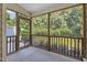 Relaxing screened porch with wood railings and lush green views, offering a serene outdoor living space at 5936 Hourglass Ct, Raleigh, NC 27612