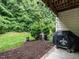 Well maintained backyard with lush greenery and grilling station at 6206 Braidwood Court Ct, Raleigh, NC 27612