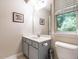 Cozy bathroom with a vanity, framed mirror, and window at 6206 Braidwood Court Ct, Raleigh, NC 27612