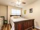 Comfortable bedroom featuring wood accents, a ceiling fan, and natural light from the window at 6206 Braidwood Court Ct, Raleigh, NC 27612