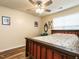 Cozy bedroom with wood-framed bed, ceiling fan, and a sunny window at 6206 Braidwood Court Ct, Raleigh, NC 27612