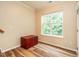 Bright bedroom featuring a window and a cozy storage chest at 6206 Braidwood Court Ct, Raleigh, NC 27612