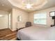 Spacious bedroom features a tray ceiling, hardwood floors, and bright natural lighting at 6206 Braidwood Court Ct, Raleigh, NC 27612