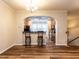 Bright dining area features hardwood floors, decorative lighting, and an open archway view to the kitchen at 6206 Braidwood Court Ct, Raleigh, NC 27612