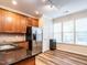 Well-lit kitchen boasts stainless steel appliances, granite countertops, and beautiful wood flooring at 6206 Braidwood Court Ct, Raleigh, NC 27612
