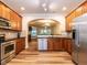 Updated kitchen with stainless steel appliances, granite countertops, and an open view to the living area at 6206 Braidwood Court Ct, Raleigh, NC 27612