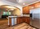 Charming kitchen features stainless steel appliances, wood cabinets and a view into the living area at 6206 Braidwood Court Ct, Raleigh, NC 27612