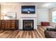 Bright living room with a fireplace, tv, and beautiful flooring at 6206 Braidwood Court Ct, Raleigh, NC 27612
