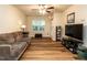 Spacious living room featuring hardwood floors, large windows, and comfortable seating at 6206 Braidwood Court Ct, Raleigh, NC 27612
