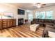Cozy living room with fireplace, tv, and beautiful wood floors at 6206 Braidwood Court Ct, Raleigh, NC 27612