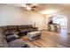 Spacious living room featuring hardwood floors, ceiling fan, and bar access to the kitchen at 6206 Braidwood Court Ct, Raleigh, NC 27612