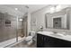 Modern bathroom featuring a tiled shower, sleek vanity, and a well-lit mirror at 6236 Pesta Ct, Raleigh, NC 27612
