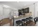 Kitchen features granite countertops, stainless appliances, a breakfast bar with seating, and hardwood floors at 6236 Pesta Ct, Raleigh, NC 27612