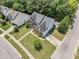 Aerial view of a charming two-story brick home with a well-manicured lawn and driveway at 712 Brittley Way, Apex, NC 27502