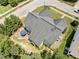 Aerial view showcasing the house, patio with seating, and landscaped yard at 712 Brittley Way, Apex, NC 27502