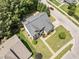 Aerial view of a charming two-story brick home with a well-manicured lawn and mature trees at 712 Brittley Way, Apex, NC 27502