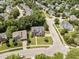 Community aerial view of a two-story brick home with a well-manicured lawn and mature trees at 712 Brittley Way, Apex, NC 27502