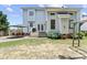 Home's backyard features an umbrella-covered seating area and a manicured lawn at 712 Brittley Way, Apex, NC 27502