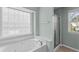 Bathroom with a whirlpool tub with jets and a walk-in shower with glass doors at 712 Brittley Way, Apex, NC 27502