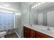 Bathroom featuring a double sink vanity, mirror, and shower with patterned curtain at 712 Brittley Way, Apex, NC 27502