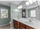 Bathroom with a dual vanity and a large mirror, with a view of a shower and tub reflected at 712 Brittley Way, Apex, NC 27502