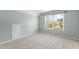 Empty bedroom with carpet and a large window overlooking an outdoor view at 712 Brittley Way, Apex, NC 27502