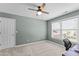 Well-lit carpeted bedroom features a ceiling fan, window, and neutral-toned walls at 712 Brittley Way, Apex, NC 27502