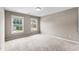Carpeted bedroom with two windows providing ample natural light and neutral-toned walls at 712 Brittley Way, Apex, NC 27502