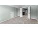 Empty bedroom with carpet and a large window and an attached room beyond a pair of doors at 712 Brittley Way, Apex, NC 27502