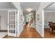 Elegant foyer featuring hardwood floors, a staircase, decorative moldings, and ample natural light at 712 Brittley Way, Apex, NC 27502