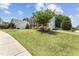 Beautifully landscaped front yard with a well-maintained lawn and charming brick home at 712 Brittley Way, Apex, NC 27502