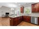 Kitchen with custom cabinets, granite countertops, and stainless steel appliances at 712 Brittley Way, Apex, NC 27502