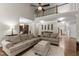 Bright living room with hardwood floors and a ceiling fan at 712 Brittley Way, Apex, NC 27502