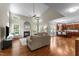 Bright living room featuring hardwood floors, a fireplace, high ceilings, and an open layout at 712 Brittley Way, Apex, NC 27502