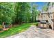 Landscaped backyard includes a built-in grill, swing, and paver patio for outdoor gatherings and enjoyment at 7552 Hasentree Club Dr, Wake Forest, NC 27587