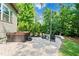 Paver patio features a hot tub and outdoor seating area, perfect for relaxation in a private setting at 7552 Hasentree Club Dr, Wake Forest, NC 27587