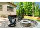 Enjoy outdoor living with a paver patio, fire pit, and comfortable seating in this backyard at 7552 Hasentree Club Dr, Wake Forest, NC 27587