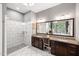Elegant bathroom with dual vanities, a granite countertop, and a walk-in shower at 7552 Hasentree Club Dr, Wake Forest, NC 27587