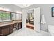 The ensuite bath features double sinks, granite countertop, and an open doorway to main bedroom at 7552 Hasentree Club Dr, Wake Forest, NC 27587