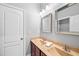 Bathroom featuring double sinks with granite countertop, framed mirrors, and a white door at 7552 Hasentree Club Dr, Wake Forest, NC 27587