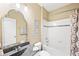 Bathroom featuring modern mirror, bath tub with shower and mosaic design in the wall at 7552 Hasentree Club Dr, Wake Forest, NC 27587