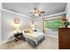 Bright bedroom with natural light, a ceiling fan, two side tables, and large windows with view at 7552 Hasentree Club Dr, Wake Forest, NC 27587