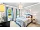 Elegant bedroom with stylish chandelier, large windows, and sophisticated decor at 7552 Hasentree Club Dr, Wake Forest, NC 27587